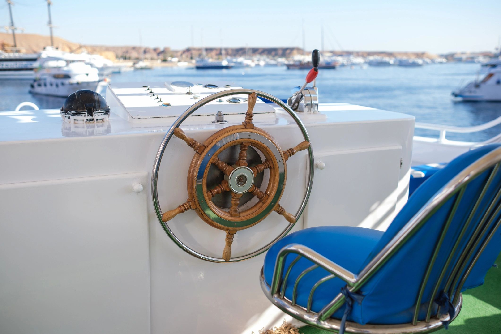 Boat helm seating and upholstered chair on a yacht deck